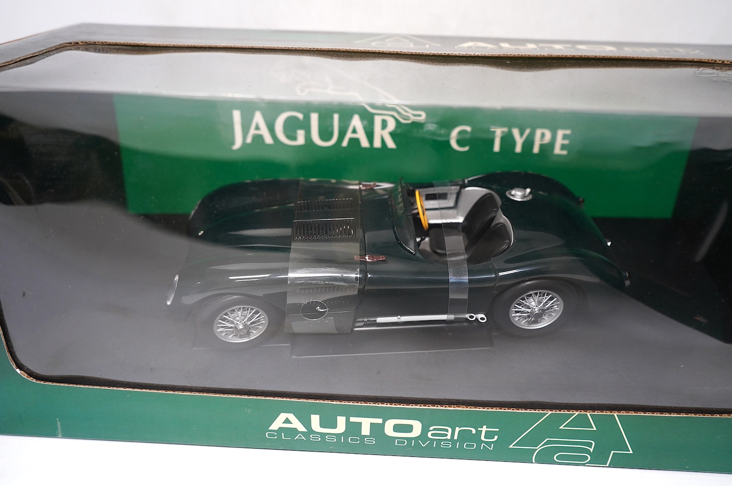 Two boxed AutoArt Classics Division 1:18 scale diecast cars; a Jaguar XKSS and a Jaguar C Type. Condition - good.